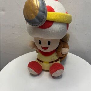 Plush Adventure Toy with Red and Yellow Accents